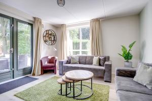 a living room with a couch and a table at 6 - Persons Lake Area 40 Bungalow in Ewijk