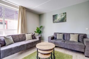 a living room with a couch and a table at 6 - Persons Lake Area 40 Bungalow in Ewijk