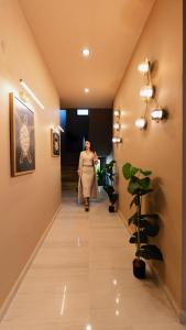 a woman walking down a hallway in a building at InOut Social in Fethiye