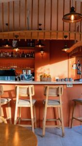 a kitchen with a counter with chairs and a bar at InOut Social in Fethiye