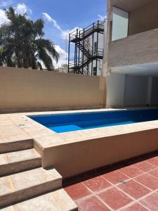 a swimming pool in front of a house at Departamento M&L Centrico in Villa María +7 photos