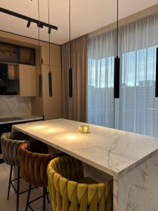 a kitchen with a large marble table and chairs at KNIGHT Villa in Voluntari