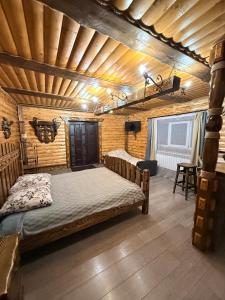 a bedroom with a bed and a wooden ceiling at Rusnak Family in Synevyrsʼka Polyana +19 photos