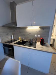 a kitchen with a sink and a counter top at Studio a 3 mn à pied des thermes in Balaruc-les-Bains +9 photos