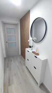 a room with a white dresser and a mirror at Riacuco in Castiñeiras +3 photos