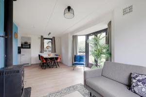 a living room with a couch and a table at 6 - Persons Lakeside 7 Bungalow in Ewijk