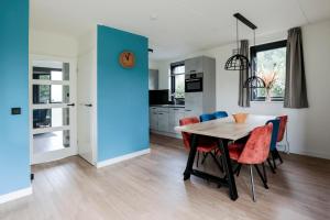 a kitchen and dining room with a table and chairs at 6 - Persons Lakeside 7 Bungalow in Ewijk