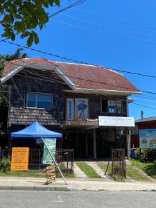 a building with a blue umbrella in front of it at Hostal Casa Damasco in Ancud +53 photos