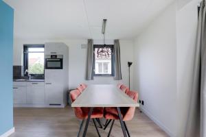 a kitchen and dining room with a table and chairs at 6 - Persons Lakeside 25 Bungalow in Ewijk