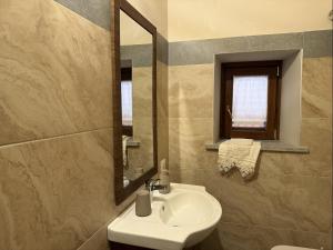 a bathroom with a sink and a mirror at Tenuta degli Ulivi - Dimora Contadina in Montecorvino Rovella +102 photos