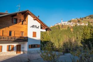 a building with a mountain in the background at Al Piol in San Nicolò di Comelico