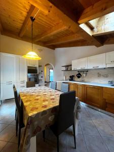 a large kitchen with a table and a dining room at Cèsa Nicole e Patrick in Campitello di Fassa