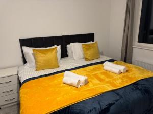 a bed with two towels on top of it at Cherry Barn Haven in Wisbech Saint Mary