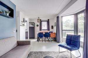 a living room with a couch and chairs and a table at 6 - Persons Lakeside 61 Bungalow in Ewijk