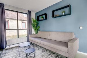 a living room with a couch and a window at 6 - Persons Lakeside 61 Bungalow in Ewijk