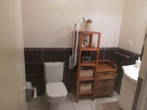 a small bathroom with a toilet and a sink at Residencia Odyssee in Vieux-Boucau-les-Bains