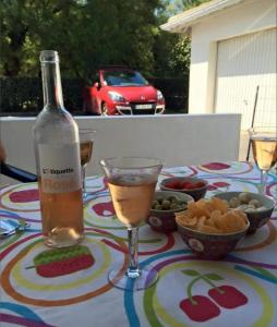 a table with a bottle of wine and a glass at Residencia Odyssee in Vieux-Boucau-les-Bains +13 photos
