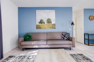 a living room with a couch and a painting on the wall at 6 - Persoons Forest 67 Bungalow in Ewijk