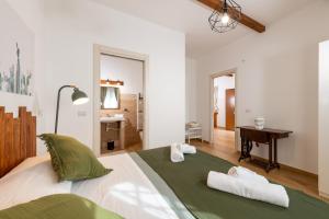 a bedroom with a bed with two towels on it at Agata's House in Viagrande