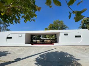 a modern house with a white exterior at The Lakefront Collective in Buriram, Thailand in Ban Nong Muang