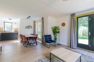 a living room with a table and chairs at 6 - Persoons Forest 151 Bungalow in Ewijk