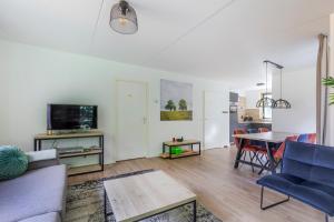 a living room with a couch and a table at 6 - Persoons Forest 151 Bungalow in Ewijk
