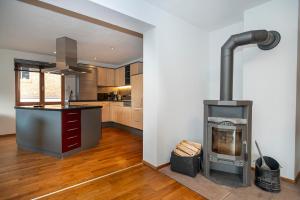 a kitchen with a wood stove in a room at Mazot Ferienhaus Kleinwalsertal in Riezlern +37 photos