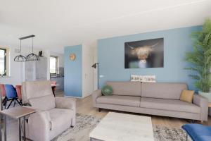 a living room with a couch and two chairs at 6 - Persoons Forest 193 Bungalow in Ewijk