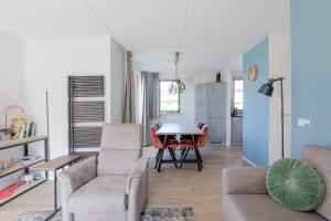 a living room with a couch and a table at 6 - Persoons Forest 193 Bungalow in Ewijk