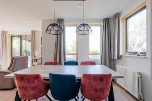 a dining room with a table and chairs at 6 - Persoons Forest 193 Bungalow in Ewijk