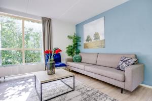 a living room with a couch and a table at 6 - Persoons Forest 231 Bungalow in Ewijk