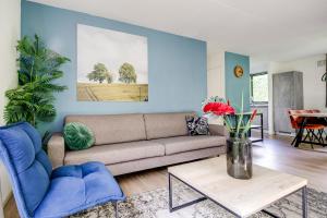 a living room with a couch and a table at 6 - Persoons Forest 231 Bungalow in Ewijk