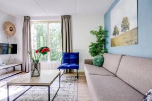 a living room with a couch and a table at 6 - Persoons Forest 231 Bungalow in Ewijk