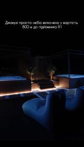 a row of blue benches in a dark room at Graal resort in Bukovel