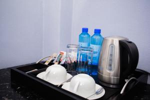 a tray with a toaster and bottles of water at Noble Hearts Bed & Breakfast in Maseru