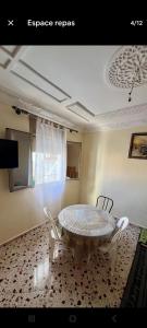 a dining room with a table and two chairs at Taghazout beachside apartment in Agadir