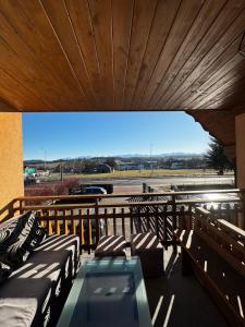 a balcony with beds and a table and a view at Spokój u Zosi in Stare Bystre