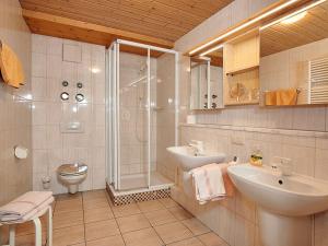 a bathroom with a shower and a sink and a toilet at Landhaus Eschenbach in Schönau am Königssee +13 photos