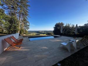 a patio with two chairs and a swimming pool at LES HAUTS DE TREMOLAT in Trémolat +24 photos