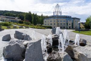 a water fountain in front of a building at Ferienwohnung Gleesbergquelle in Aue-Bad Schlema +8 photos