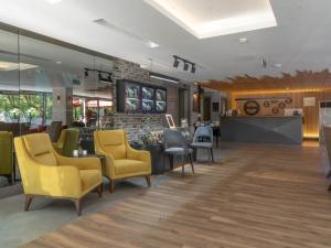 una sala d'attesa con sedie gialle e bancone di Laren Sea Side Hotel Spa a Antalya (Adalia)