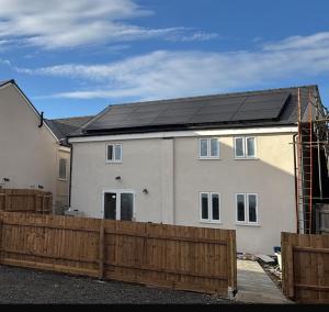 a house with a solar roof on top of it at Pear Barn Haven in Wisbech Saint Mary