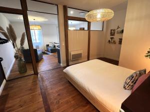 a room with a bed and a living room at La Galupe in Mont-de-Marsan