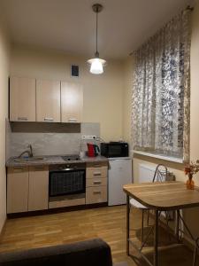 a kitchen with a table and a dining room at SUNNY holidays in Liepāja