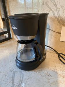 a black coffee maker sitting on a counter at Casona La Carolina in San Andrés