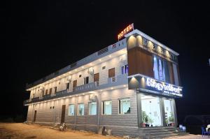 a building with a neon sign on top of it at Bhagyashree hotel & restuarant osian in Osiān