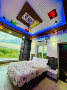 a bedroom with a large bed in front of a window at Bhagyashree hotel & restuarant osian in Osiān