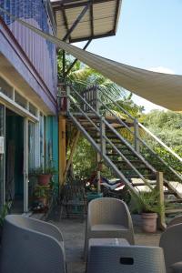 an outdoor patio with chairs and a staircase at EL TUMBO in El Gigante