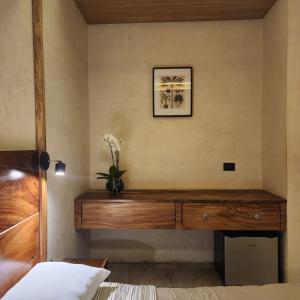 a bedroom with a wooden dresser with flowers on it at Casa Josefina in Hunucmá +45 photos
