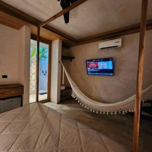 a living room with a tv on the wall at Casa Josefina in Hunucmá